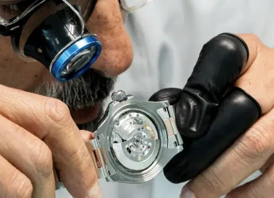 Mr. Aiman with a loupe looking at the Rolex Oyster watch