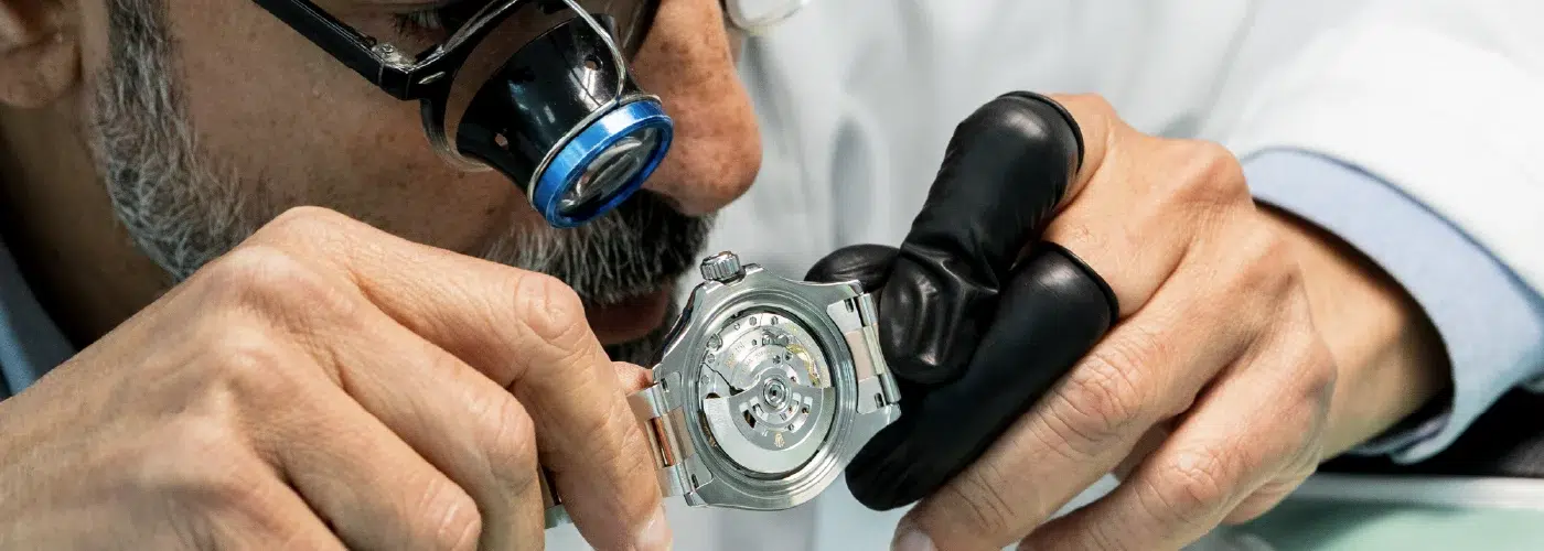 Mr. Aiman with a loupe looking at the Rolex Oyster watch